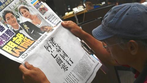 Man reads a newspaper in Taiwan