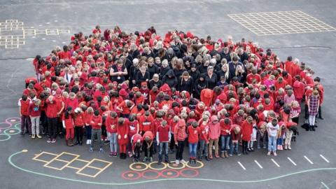 West Ewell Primary School in Surrey gathered in the shape of a poppy to mark the WW1 centenary