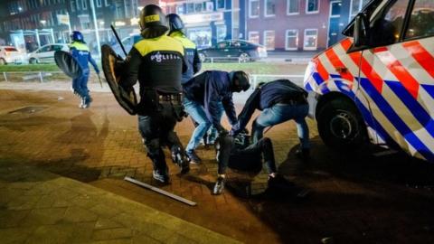 A man is arrested by Police during clashes in Rotterdam, The Netherlands