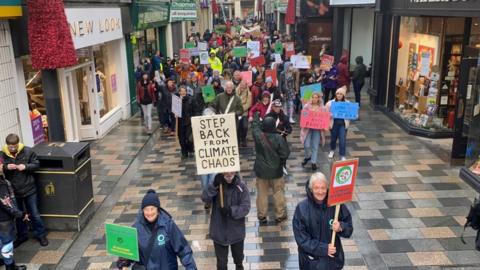 Protestors marching through Douglas town centre