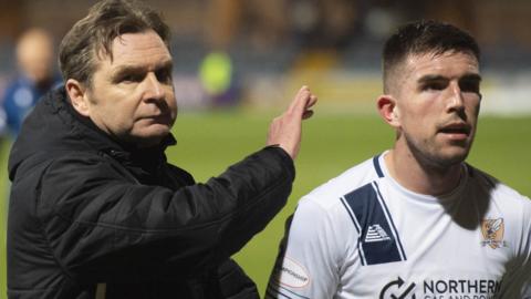 Alloa Athletic manager Peter Grant congratulates one of his players