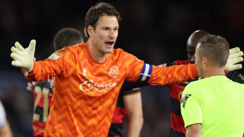 Asmir Begovic remonstrates with the referee after he is sent off at Leeds