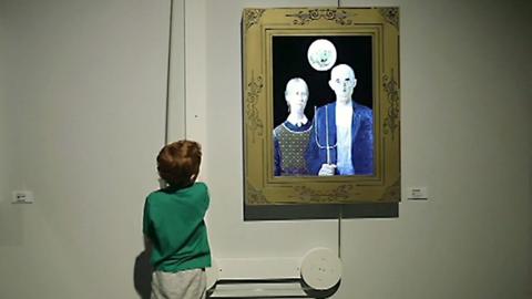 A child uses an interactive art exhibit at a museum