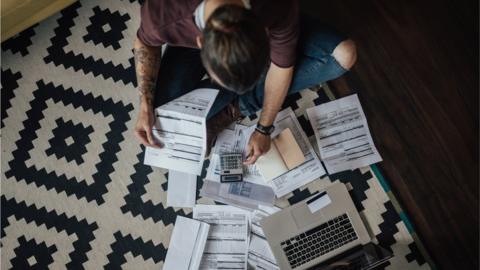 A man surrounded by bills