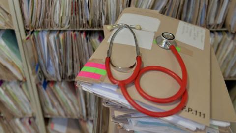 Stethoscope on top of patient files