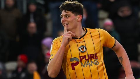 Newport County's Seb Palmer-Houlden gestures to Wrexham fans after scoring a goal