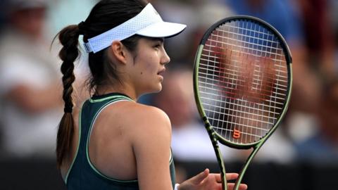 Emma Raducanu holding her racquet