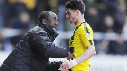 Joe Powell receives instructions from boss Jimmy Floyd Hasselbaink