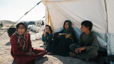 Many survivors, like these residents of Siah Ab, are staying outdoors for fear of more aftershocks