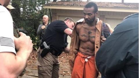 Officers arresting Marks, who is barefoot