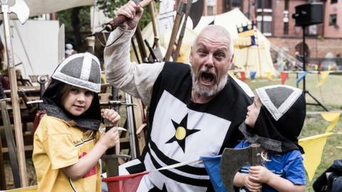 Actor in costume pictured with axe