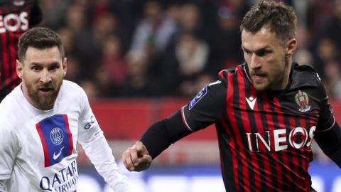 Nice's Aaron Ramsey takes on Lionel Messi, then of Paris St Germain