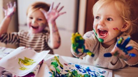 Children painting on kitchen table