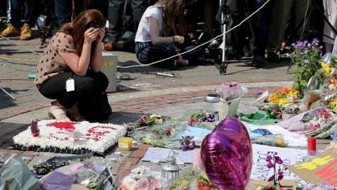 Balloons and flowers at a makeshift memorial at St Ann"s Square, Manchester