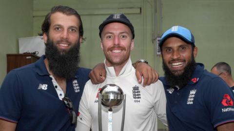 England spinners Moeen Ali (left), Jack Leach (centre) and Adil Rashid (right) smile as they hold the trophy after beating Sri Lanka