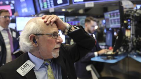 Traders and financial professionals work ahead of the closing bell on the floor on the New York Stock Exchange (NYSE), October 26, 2018 in New York City.