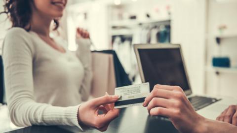 Woman paying with card (generic)