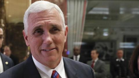 Vice President-elect Mike Pence walks past the media as he leaves Trump Tower with his wife Karen, Tuesday, Nov. 15, 2016,