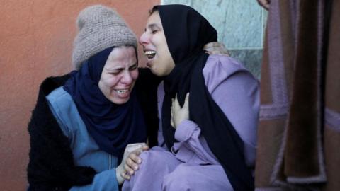 Mourners react next to the bodies of Palestinians killed in Israeli strikes on Al-Mawasi where displaced Palestinians shelter, according to a health ministry official, at a hospital in Khan Younis in the southern Gaza Strip