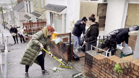 People cleaning up after the riot