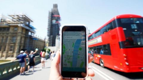 Mobile phone with Uber app in front of Big Ben