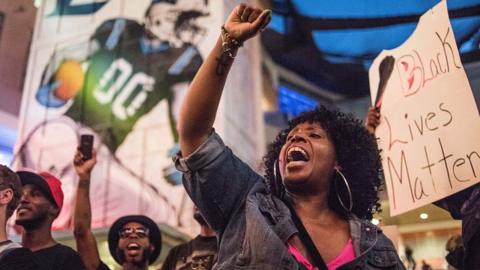 A demonstrator shouts while participating in protests September 21, 2016 in downtown Charlotte, NC