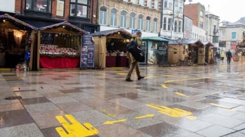 A man walks past Cardiff's Christmas market