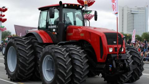 Tractors are paraded past Belarusian President Alexander Lukashenko on July 3, 2017 in Minsk, Belarus