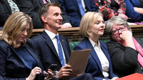 Chancellor of the Exchequer Jeremy Hunt next to British Prime Minister Liz Truss and in the House of Commons, in London