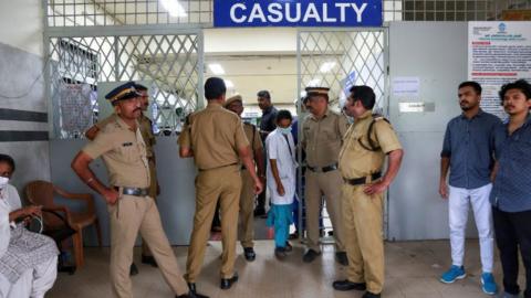 Policemen stand guard at the entrance of the casualty ward of a hospital where injured devotees were admitted after multiple blasts occurred during a religious gathering of Jehovah's Witnesses, in Kochi, India, October 29, 2023.