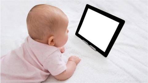 Baby looking at a tablet