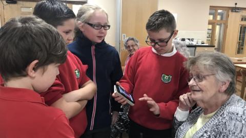 Schoolchildren visiting residents at Cardiff care home