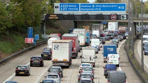 Slow-moving traffic on the M25 near Addlestone, Surrey