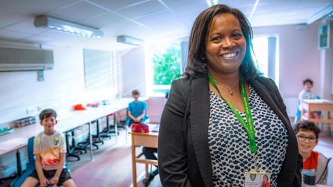 Headteacher Allana Gay and pupils smiles