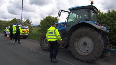 Lancashire Police officers checking a tractor