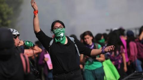 Woman gestures as participants mark International Women's Day in Mexico City8 March 2020