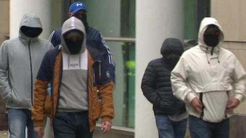 Masked men outside Laganside Courts