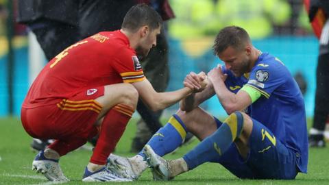 Wales' Ben Davies consoles Ukraine's Andriy Yarmolenko