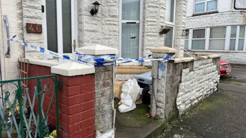 Blue and white police tape at the entrance to a house in Great Yarmouth