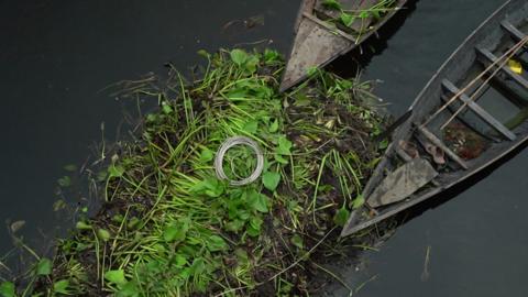 boats resting against floating farm