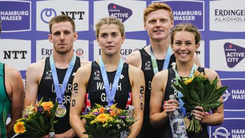 A photo of the British mixed relay triathlon team - (Left to right) Barclay Izzard, Kate Waugh, Samuel Dickinson and Sian Rainsley receive their medals