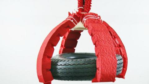 A soft robot lifting a car tyre