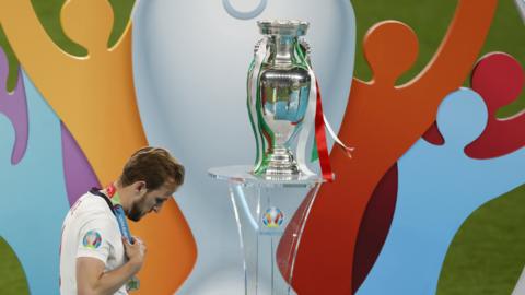 Harry Kane walks past European Championship trophy after losing to Italy