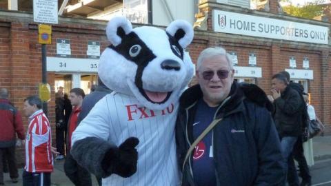 Jonathan Kotler with Billy the Badger, Fulham FC's mascot, outside Craven Cottage in west London