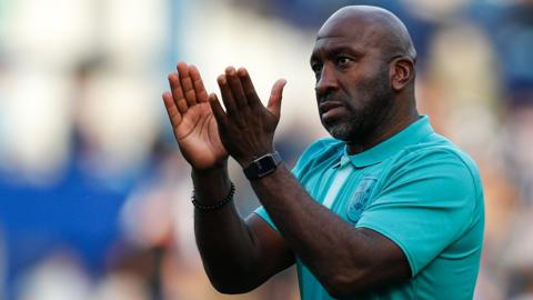 Huddersfield Town boss Darren Moore claps the fans