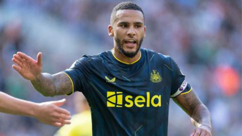 Jamaal Lascelles holds out one arm