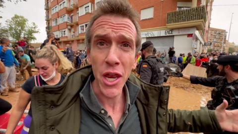 The 鶹Լ's Mark Lowen stands amidst scenes of chaos and flooding damage in Paiporta, the worst hit suburb of Valencia