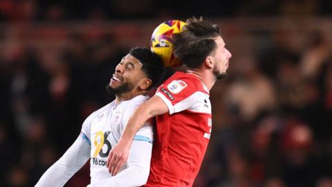 Middlesbrough's Dan Barlaser and Burnley player Josh Laurent challenge for the ball in the air