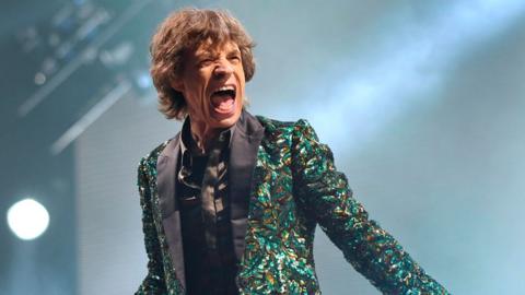 Rolling Stones frontman Sir Mick Jagger singing on stage