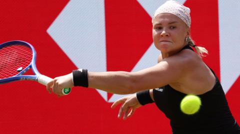 Diana Shnaider slices a backhand
